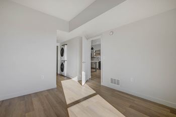 a living room with white walls and wood floors